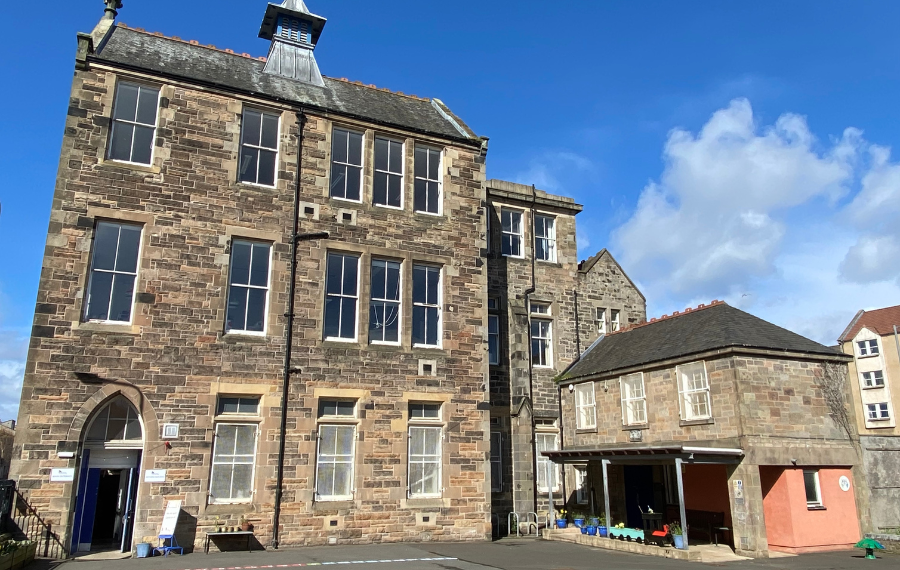 Heart of Newhaven Community A three storey, grey brick old school building with large sash windows.