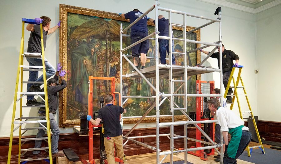 Star of Bethlehem – (Credit: Birmingham Museum & Gallery Trust) Four men using stepladders and scaffolding are mounting the Star of Bethlehem, a very large and colourful watercolour painting, on the wall