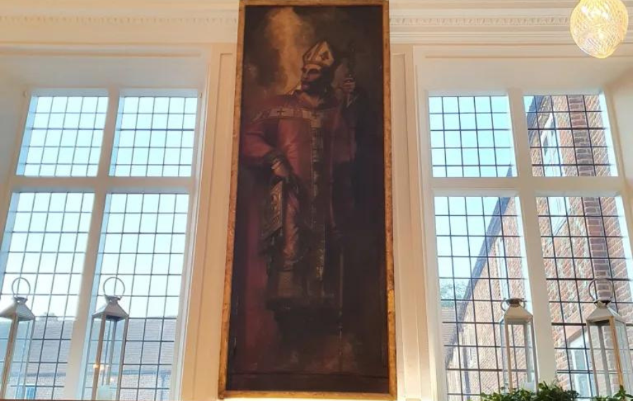 Thomas A Becket (Credit: Fulham Palace) A picture of a large painting of a white man in red and gold Christian-style, religious garments. Painted in an old, romantic style.