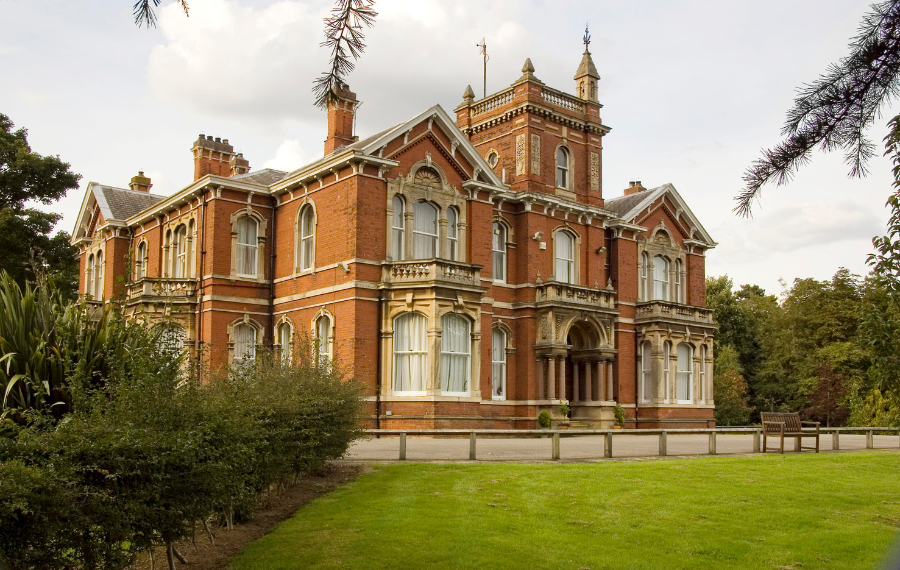 Weelsby Hall (Credit: Linkage Community Trust) A Victorian, two story, large red brick manor house sits surrounded by lawns and green.