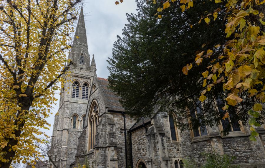 Outdoor image of the steeple of St Mary's Church - a grey, gothic style church.